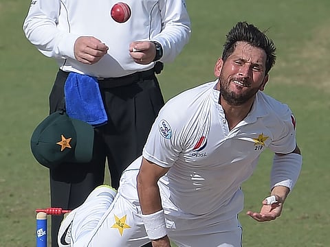 Pakistan spinner Yasir Shah delivers the ball during the fourth day of the second Test match against New Zealand at the Dubai International Stadium on November 27, 2018. 