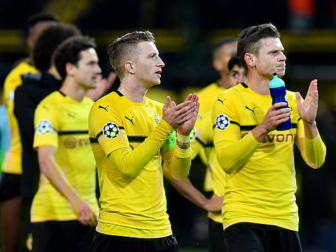 Dortmund's Marco Reus, center, and his team mates applaud to supporters.