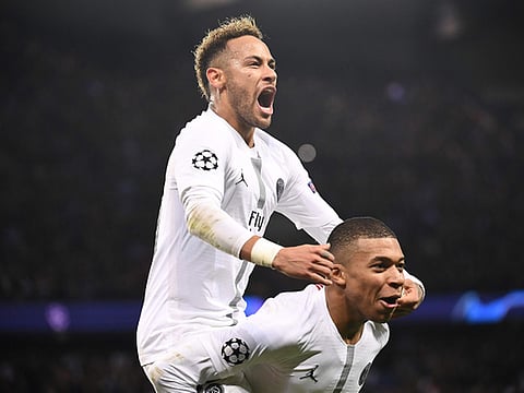Paris St-Germain's Neymar celebrates with Kylian Mbappe.