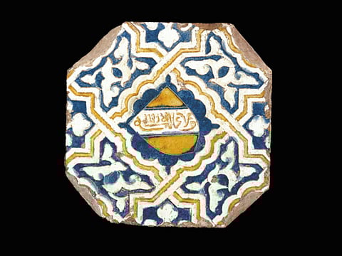 Alhambra tile, late 14th century, Malaga or Granada, Spain. Earthenware, painted over and incised in an opaque white glaze