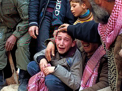 Ahmed, center, mourns his father Abdulaziz Abu Ahmed Khrer, who was killed by a Syrian Army sniper, during his funeral in Idlib, north Syria, Thursday, March 8, 2012. (AP Photo/Rodrigo Abd)