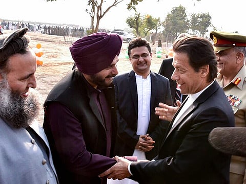  Pakistan's Prime Minister Imran Khan shakes hands with cricketer-turned-Indian politician Navjot Singh Sidhu during ground breaking ceremony for Kartarpur corridor in Pakistan's Kartarpur, Wednesday, Nov. 28, 2018. 