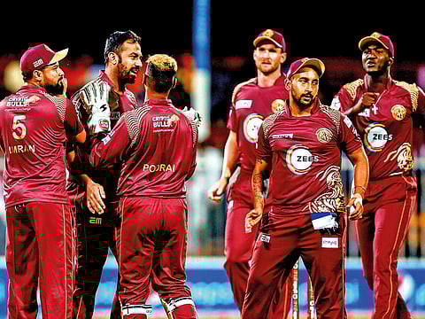 Northern Warriors’ Wahab Riaz celebrates with his teammates after taking claiming a wicket in Sharjah.