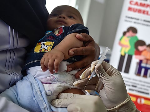 A medical worker injects a baby with a measles-rubella (MR) vaccine at a health station in Banda Aceh in Aceh province.  Measles cases worldwide jumped more than 30 percent last year compared to 2016.