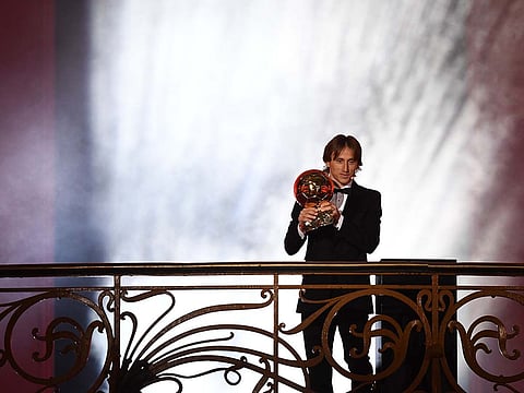 Real Madrid's Croatian midfielder Luka Modric holds the trophy after receiving the 2018 FIFA Men's Ballon d'Or award.