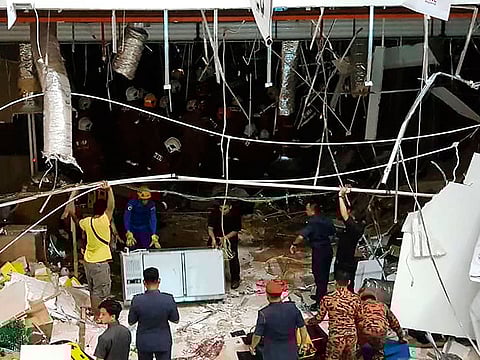 Malaysian security personnel inspect the site after an explosion at the City One Megamall in Kuching, the capital city of Sarawak state, on December 4, 2018. 