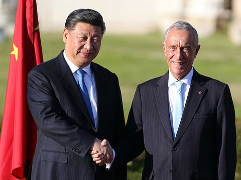 China's President Xi Jinping and Portuguese President Marcelo Rebelo de Sousa, right, pose for photos during a welcome ceremony outside Lisbon's 16th century Jeronimos Monastery Tuesday, Dec. 4, 2018. Xi started Tuesday a two-day state visit to Portugal. 