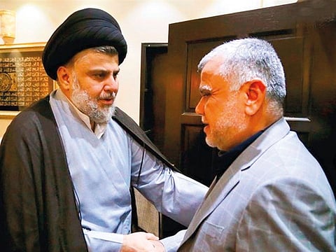 Cleric Moqtada Al Sadr (left) has been pitching for an apolitical man for the interior ministry against Hadi  Al Amiri’s (right) candidate Falih Al Fayyadh.