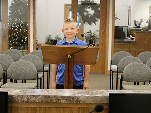 9-year-old Dane Best poses in the council chambers in Severance, Colorado.
