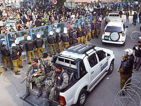 A security convoy transporting arrested opposition leader Shahbaz Sharif enters the corruption court premises for a case hearing in Lahore on December 6, 2018.  