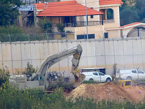 Israeli military digger works on the border with Lebanon in the northern Israeli town of Metula, Tuesday, Dec. 4, 2018.