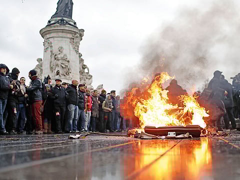 A bin burns during a protest in Paris. France was bracing for fresh violence, following chaos in Paris last weekend, with thousands of protesters railing against rising prices.