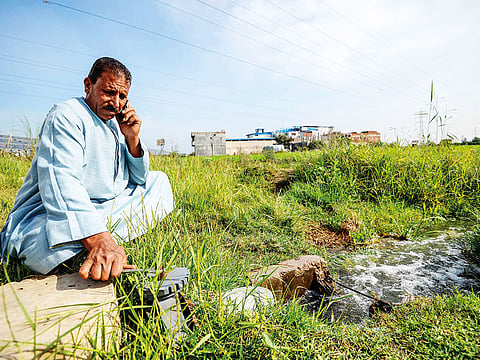 A farmer closes the valve of a pump in Kafr Al Dawar village in northern Egypt’s Nile Delta.