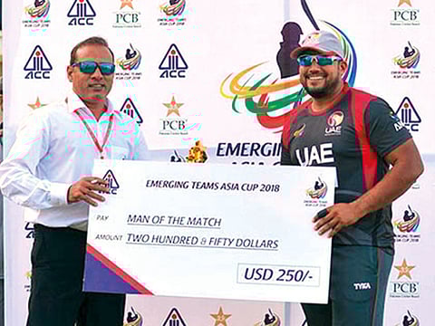 UAE opener Ashfaq Ahmad receives the man of the match award against Bangladesh Emerging team in the ACC Emerging Cup tournament in Karachi.