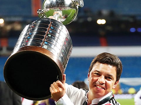 River Plate coach Marcelo Gallardo celebrates with the trophy after winning the Copa Libertadores final against Boca Juniors in Santiago Bernabeu.
