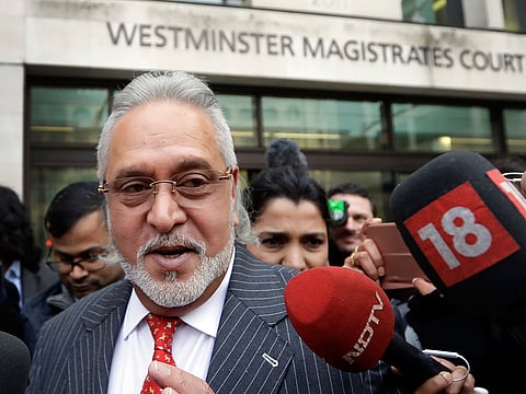 Indian business man Vijay Mallya is surrounded by the media as he leaves Westminster Magistrates Court in London, Monday, Dec. 10, 2018.