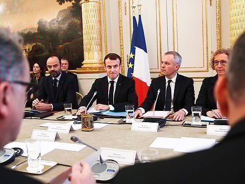 From left: French Prime Minister Edouard Philippe, French President Emmanuel Macron, French Ecology Minister Francois de Rugy and French Labour Minister Muriel Penicaud meet with representatives of trade unions, employers' organisations and local elected officials at the Elysee presidential palace in Paris