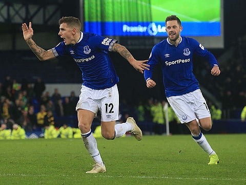 Everton's French defender Lucas Digne (L) celebrates scoring.