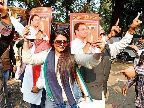 India's Congress party supporters celebrate outside the party headquarters in New Delhi on December 11, 2018, as vote counting in five Indian states began. 