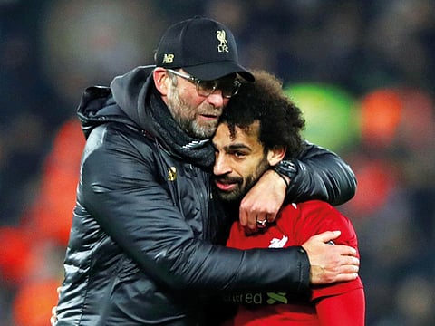 Liverpool manager Juergen Klopp celebrates with Mohammad Salah, who scored their only goal to help the team beat Napoli 1-0 to make it to the Champions League knockout stages.