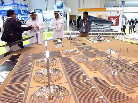 File: Visitors look at the model of Mohammad Bin Rashid Al Maktoum Solar Park in Dubai, at DEWA pavilion during the Abu Dhabi Sustainability Week 2018 at ADNEC.