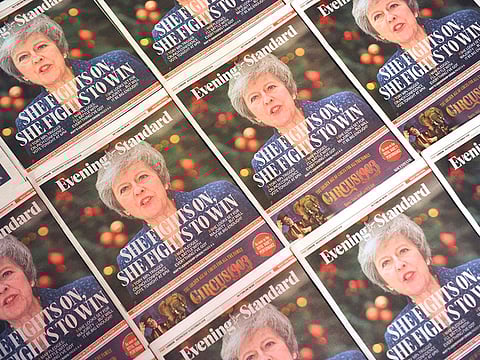 Copies of the Evening Standard, London's daily free newspaper with Britain's Prime Minister Theresa May on the front cover following the confidence vote are arranged in  London on December 12, 2018. 