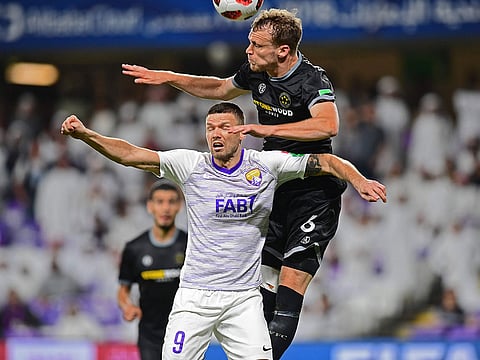 Team Wellington's defender Taylor Schrijvers (R) vies for the header with Al-Ain's forward Marcus Berg (C) during the opening match of the FIFA Club World Cup 2018 football tournament between UAE's Al-Ain and New Zealand's Team Wellington at the Hazza Bin Zayed Stadium in Abu Dhabi, the capital of the United Arab Emirates, on December 12, 2018.