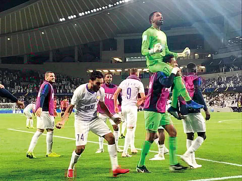Goalkeeper Khalid Eisa is carried around by teammates after Al Ain registered a win over Wellington during the Fifa Club World Cup at Hazza Bin Zayed Stadium on Wednesday night.