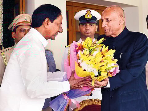 Telangana Governor E.S.L. Narasimhan greets newly sworn in Telangana Chief Minister K. Chandrashekar Rao at Raj Bhawan in Hyderabad.