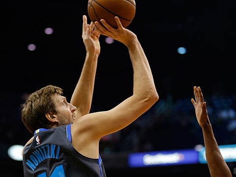 Dallas Mavericks forward Dirk Nowitzki scores against the Phoenix Suns in the first half during an NBA basketball game, Thursday, Dec. 13, 2018, in Phoenix. 