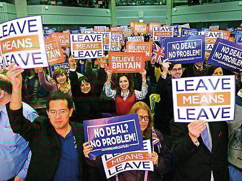 Attendees hold up signs at a political rally organised by the pro-Brexit Leave Means Leave campaign group in central London.