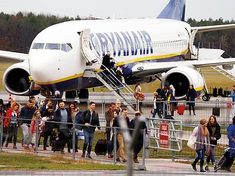 Passengers disembark from a Ryanair aircraft at the airport in Modlin, near Warsaw, Poland