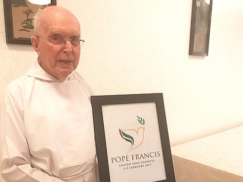 Fr. Gandolf Wild holding a framed message to the Pope. 