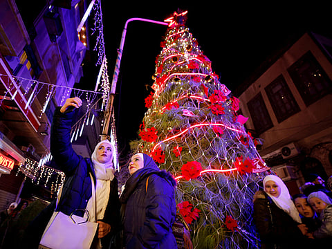 A boy sells sweets in the ancient quarter of Bab Sharqi in Damascus