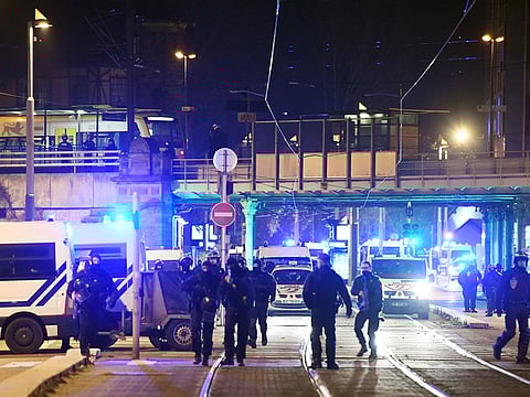 French police officers block the road near the site where Cherif Chekatt, the alleged gunman who had been on the run since allegedly killing three people at Strasbourg's popular Christmas market, has been shot dead by police on December 13, 2018 in the Neudorf neighbourhood of Strasbourg.