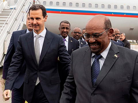 Syrian President Bashar Al Assad, left, meets with Sudan's President Omar Al Bashir in Damascus, Syria, Sunday, Dec. 16, 2018.