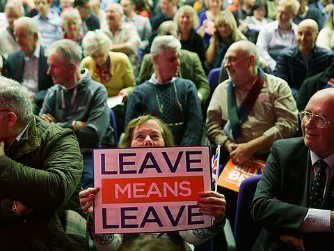 An attendee holds up a banner at a political rally organised by the pro-Brexit Leave Means Leave group in central London.