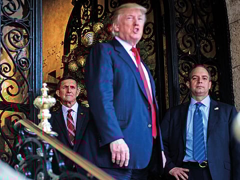 Michael Flynn (left) with US President Donald Trump and the then chief-of-staff Reince Priebus (right) at Mar-a-Lago in Palm Beach, Florida, in December 2016. 