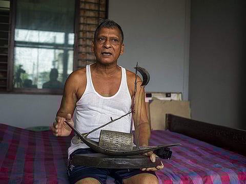 Bangladeshi swimmer Kshitindra Baisya talks during an interview with AFP at his house in Dhaka.