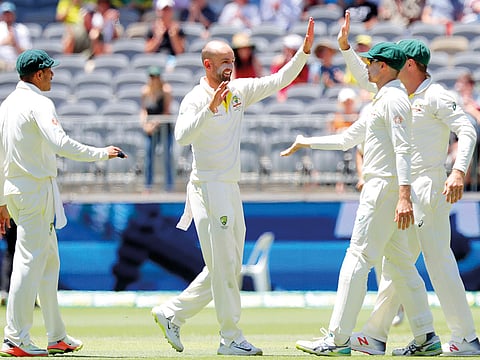 Australia's Nathan Lyon (2nd L) is congratulated by his teammates after dismissing India's Rishabh Pant on day five of the second test match between Australia and India at Perth Stadium in Perth, Australia, December 18, 2018.