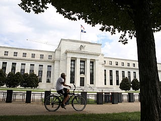 US Fed holds rates, sees slower growth and higher inflation