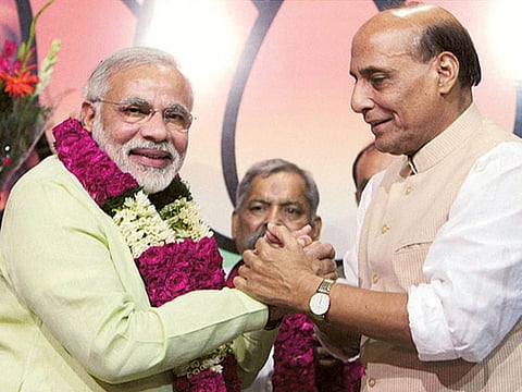 BJP President Rajnath Singh greets Gujarat Chief Minister Narendra Modi after declaring him the party's Prime Ministerial candidate for 2014 Lok Sabha polls, in New Delhi on Friday.