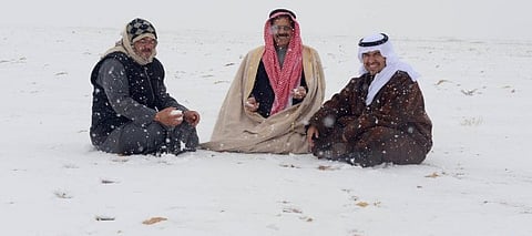 File picture shows Saudi men enjoying the snow in the northern regions of the kingdom.