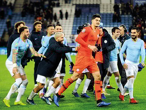 Manchester City’s goalkeeper Arijanet Muric (centre) celebrates with teammates in front of their fans after winning the League Cup quarter-finals.