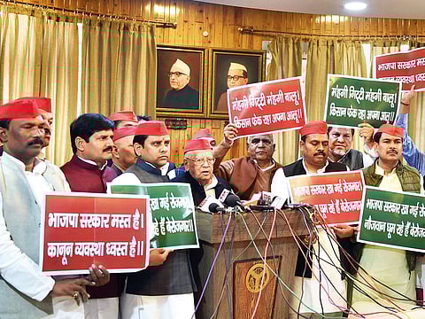Samajwadi Party MLCs hold placards with slogans against Yogi government’s communal agenda, while addressing the media in the Vidhan Sabha in Lucknow yesterday.