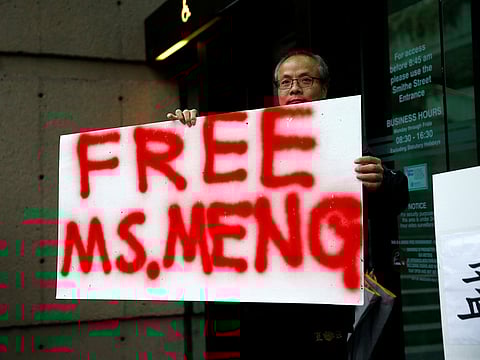 Robert Long holds a sign outside the B.C. Supreme Court bail hearing of Huawei CFO Meng Wanzhou, who was held on an extradition warrant in Vancouver, British Columbia, Canada December 11, 2018.