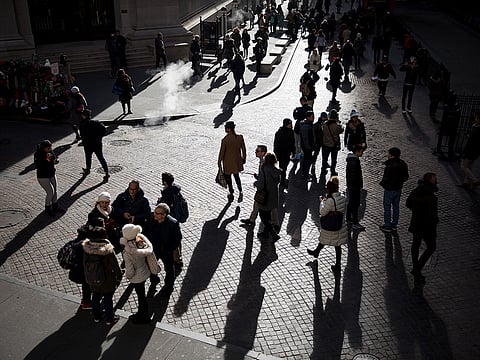 Pedestrians walk along Wall Street in front of the New York Stock Exchange (NYSE) in New York, U.S., on Wednesday, Dec. 19, 2018. 