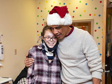 Former US President Barack Obama delivering gifts, greeting patients and their parents at Children’s National Medical Center in Washington, DC, December 19, 2018.