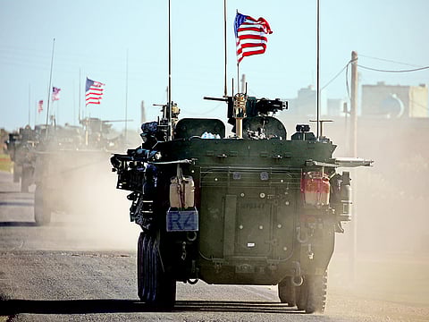 A convoy of US armoured vehicles drives near the village of Yalanli on the western outskirts of the northern Syrian city of Manbij in March 2017. 