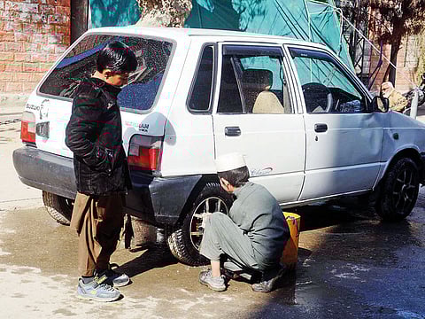 A child washing a car in Lahore. The Lahore court has ordered Punjab government to ban children working as domestic help.